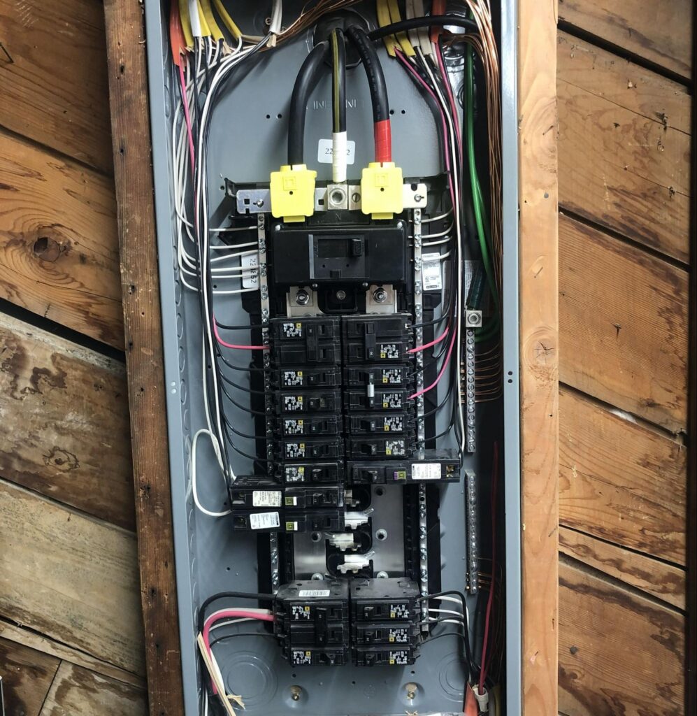 Interior of a modern electrical panel with organized breakers after a home renovation upgrade.