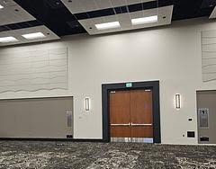 A commercial event hall lit with recessed ceiling fixtures installed by a professional electrical team.
