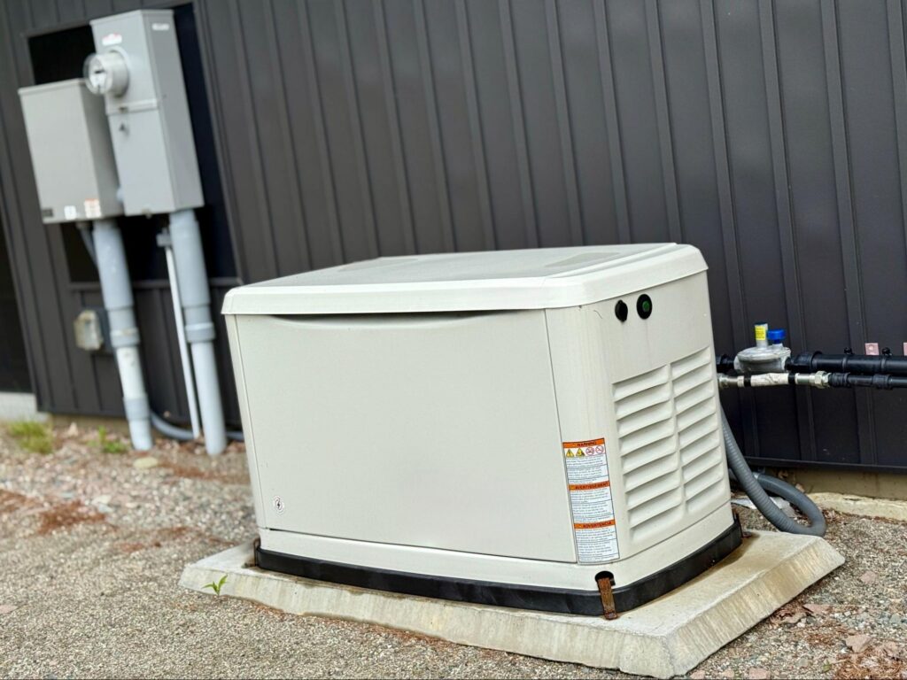 Whole-home standby generator installed on a concrete pad beside a Boise Bench home.